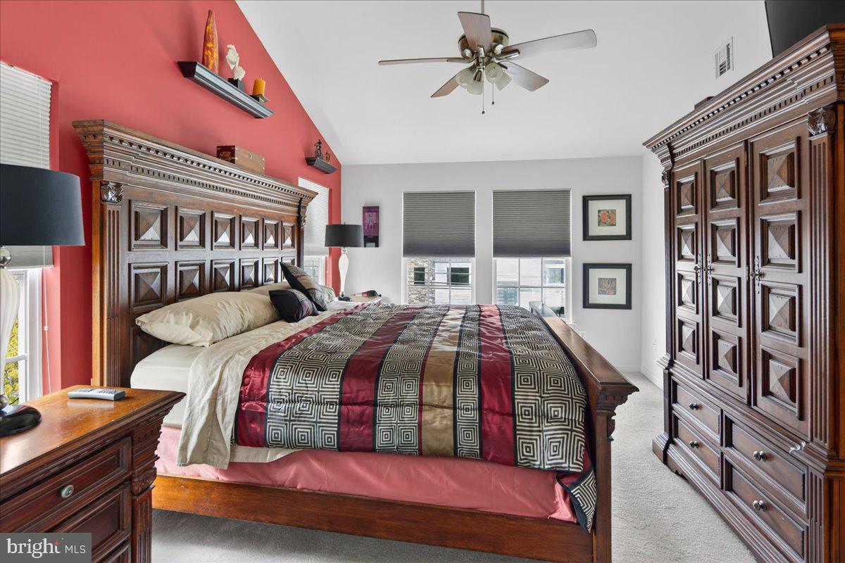 116 Marine Road Waretown, NJ 08758 - Photo 22 of 67 a bedroom with a bed and a chandelier