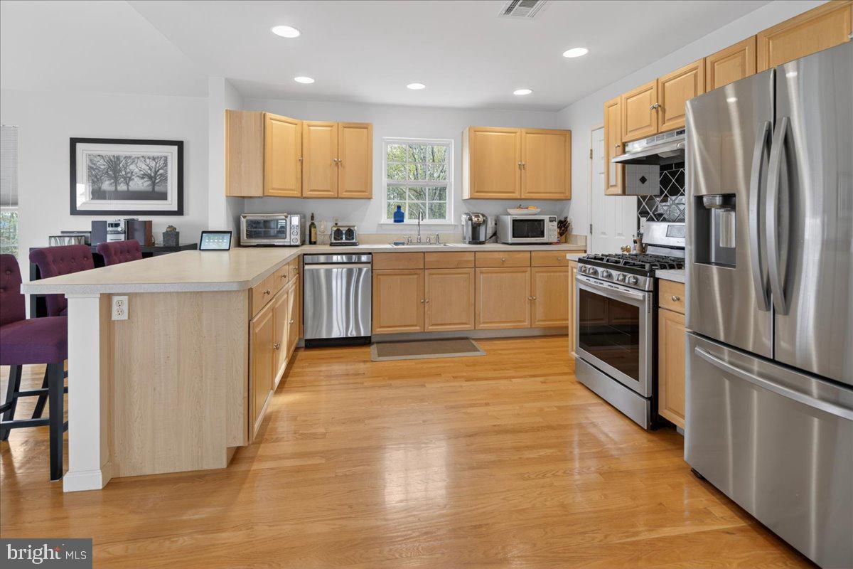 116 Marine Road Waretown, NJ 08758 - Photo 28 of 67 a kitchen with stainless steel appliances granite countertop a refrigerator a stove a sink dishwasher and a refrigerator