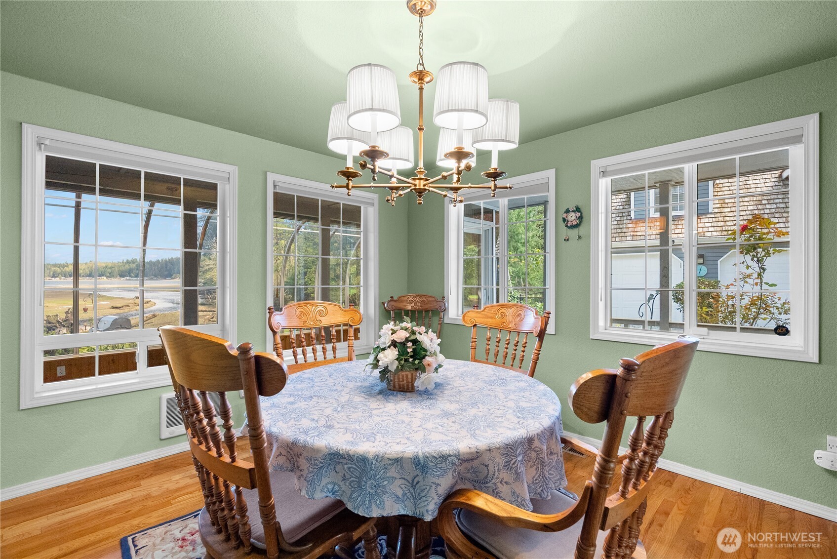 8320 East Grapeview Loop Road Allyn, WA 98524 - Photo 10 of 38 a dining room with furniture a chandelier and wooden floor