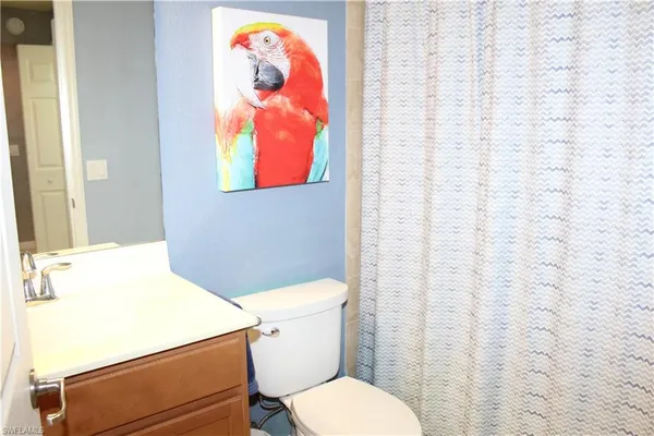 a white toilet sitting next to a bathroom sink