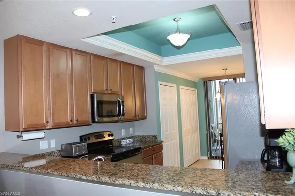 a kitchen with a stove a sink and a refrigerator