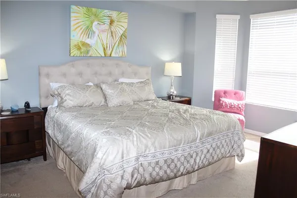 a bed sitting in a bedroom next to a window