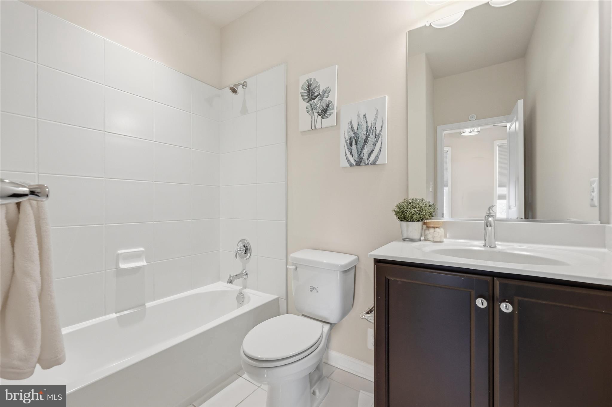 1090 Holden Road Frederick, MD 21701 - Photo 25 of 60 a bathroom with a granite countertop sink a toilet a mirror a bathtub and shower