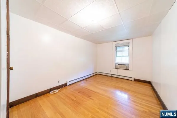 a view of a room with a wooden floor and a window