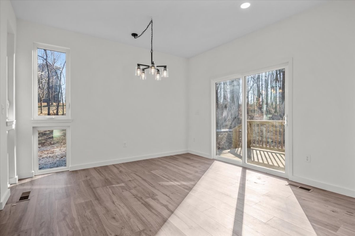 1050 Promise Land Road Charlotte, TN 37036 - Photo 11 of 29 wooden floor in an empty room with a window