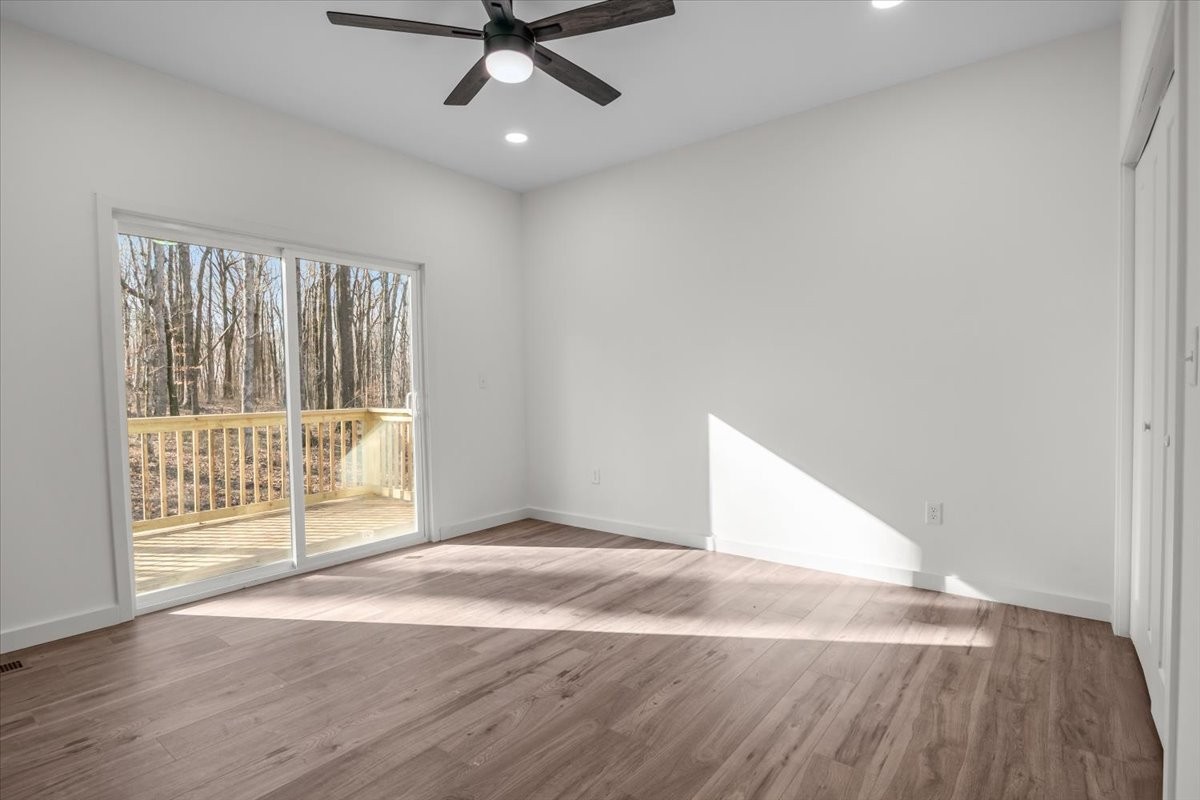 1050 Promise Land Road Charlotte, TN 37036 - Photo 13 of 29 a view of an empty room with wooden floor and a window