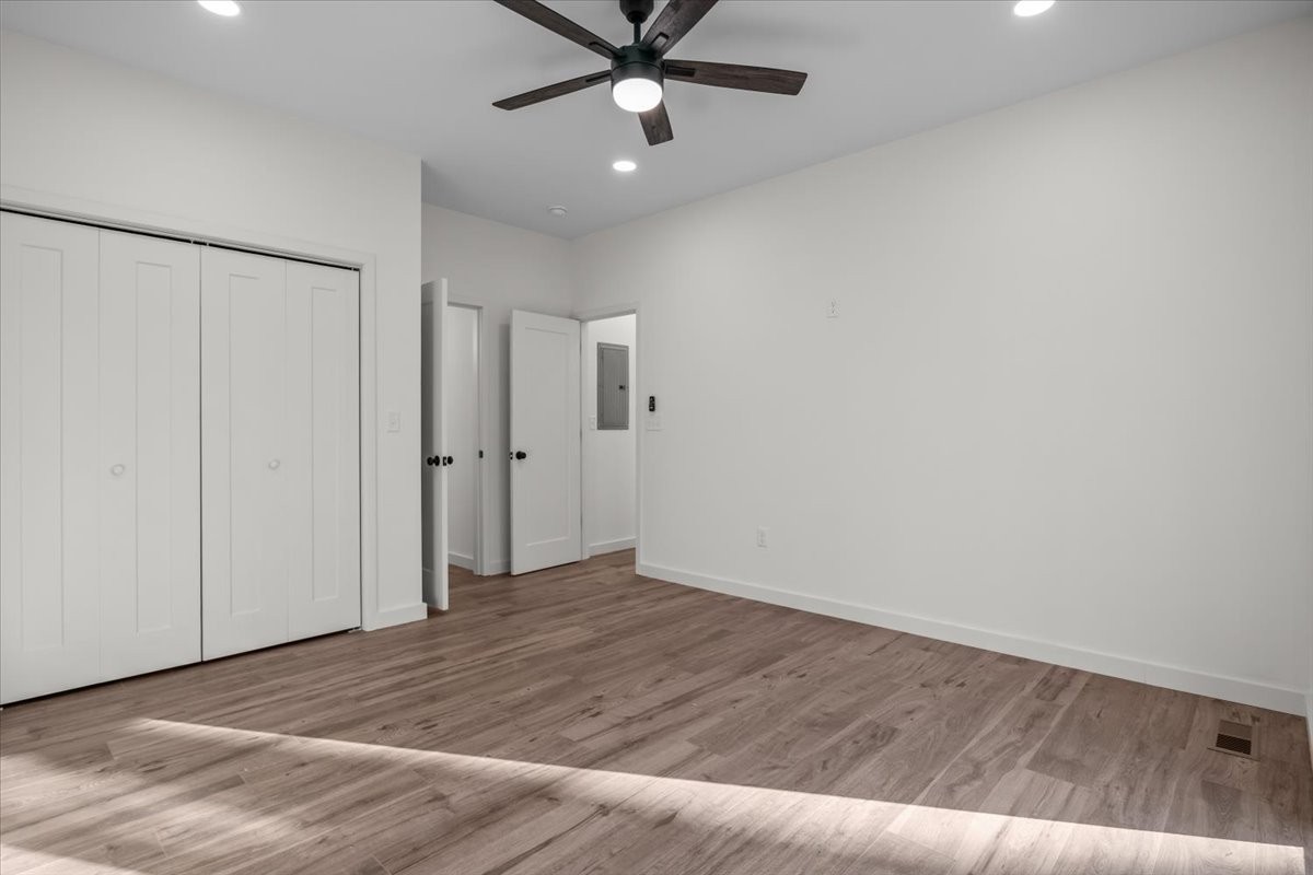 1050 Promise Land Road Charlotte, TN 37036 - Photo 14 of 29 wooden floor in an empty room with a ceiling fan