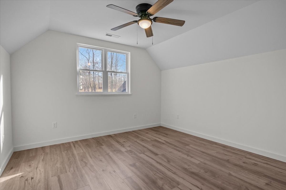 1050 Promise Land Road Charlotte, TN 37036 - Photo 17 of 29 wooden floor in an empty room with a window