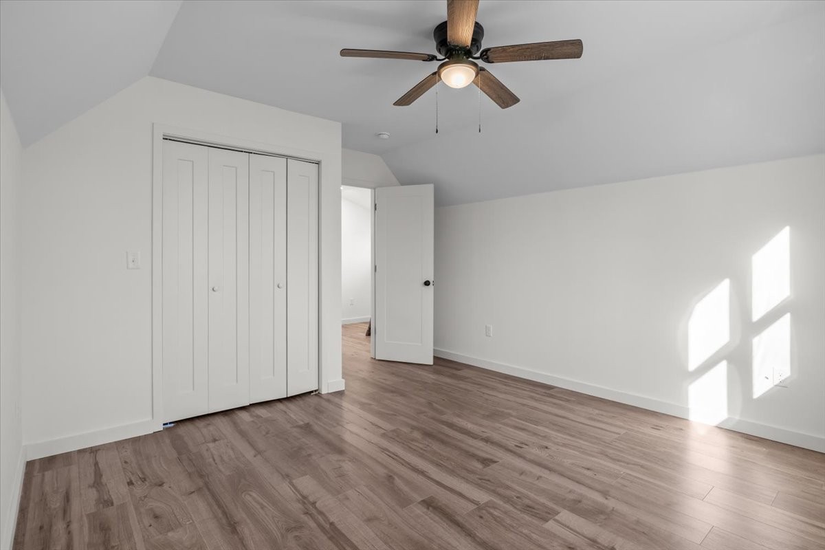 1050 Promise Land Road Charlotte, TN 37036 - Photo 18 of 29 an empty room with wooden floor fan and windows
