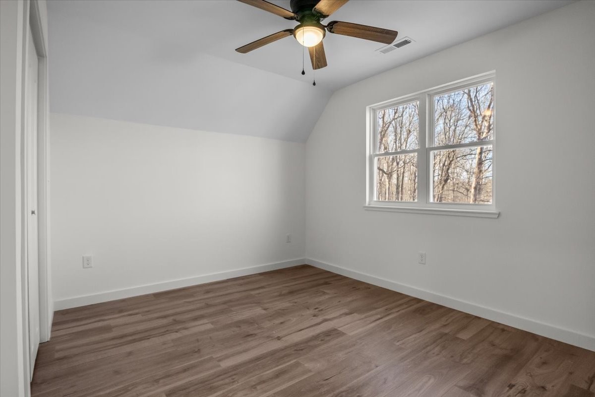 1050 Promise Land Road Charlotte, TN 37036 - Photo 19 of 29 a view of an empty room with wooden floor and a window