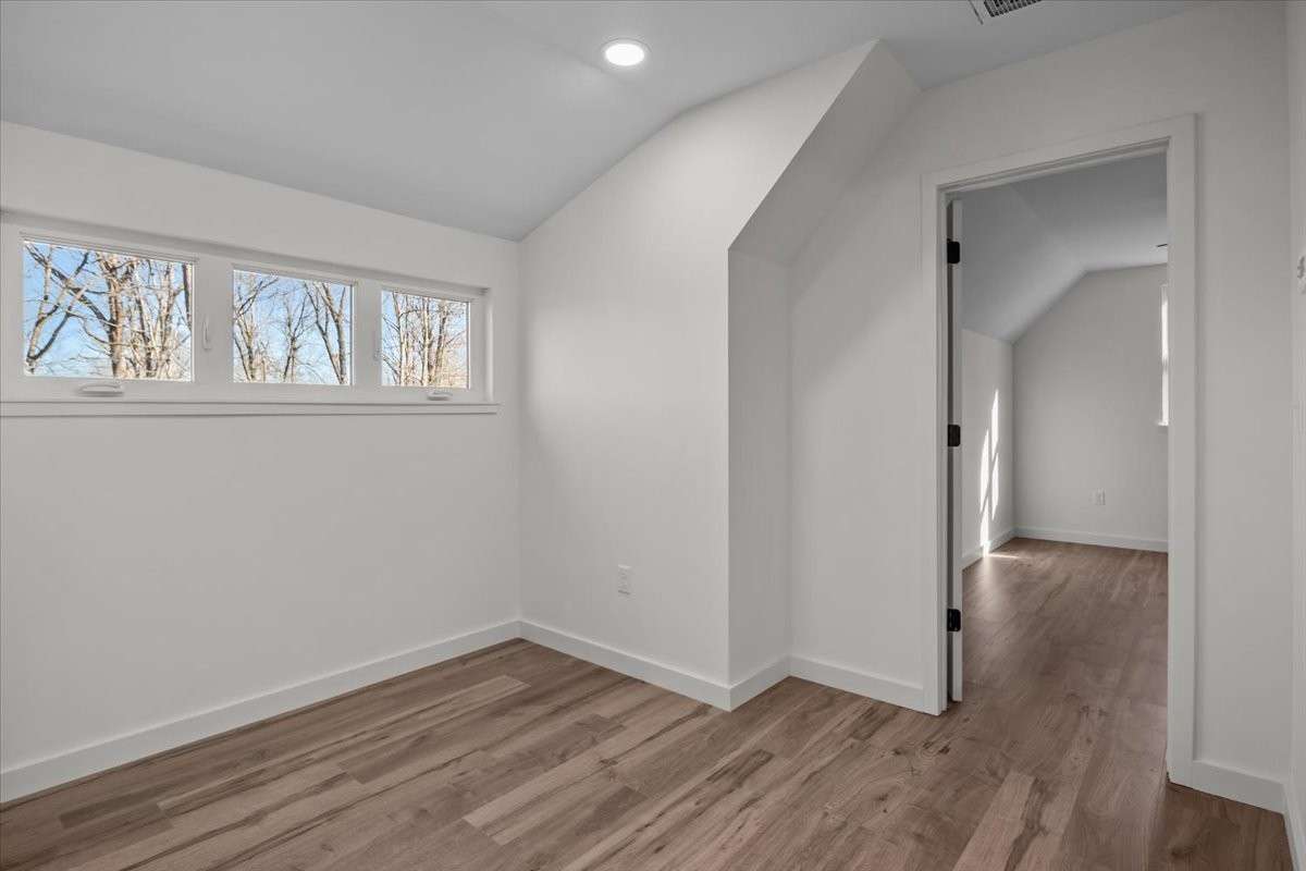 1050 Promise Land Road Charlotte, TN 37036 - Photo 24 of 29 a view of an empty room with wooden floor and a window