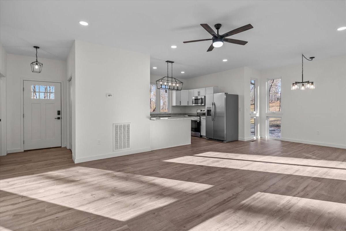 1050 Promise Land Road Charlotte, TN 37036 - Photo 4 of 29 a view of a kitchen with a sink a refrigerator and a counter top space