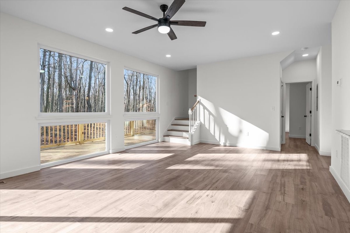 1050 Promise Land Road Charlotte, TN 37036 - Photo 5 of 29 a view of a hallway with wooden floor and a ceiling fan