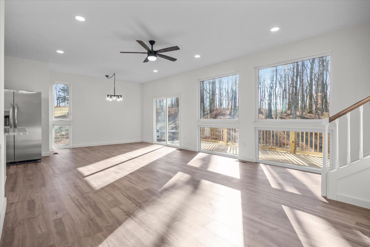 1050 Promise Land Road Charlotte, TN 37036 - Photo 6 of 29 a spacious bedroom with a large bed and a chandelier