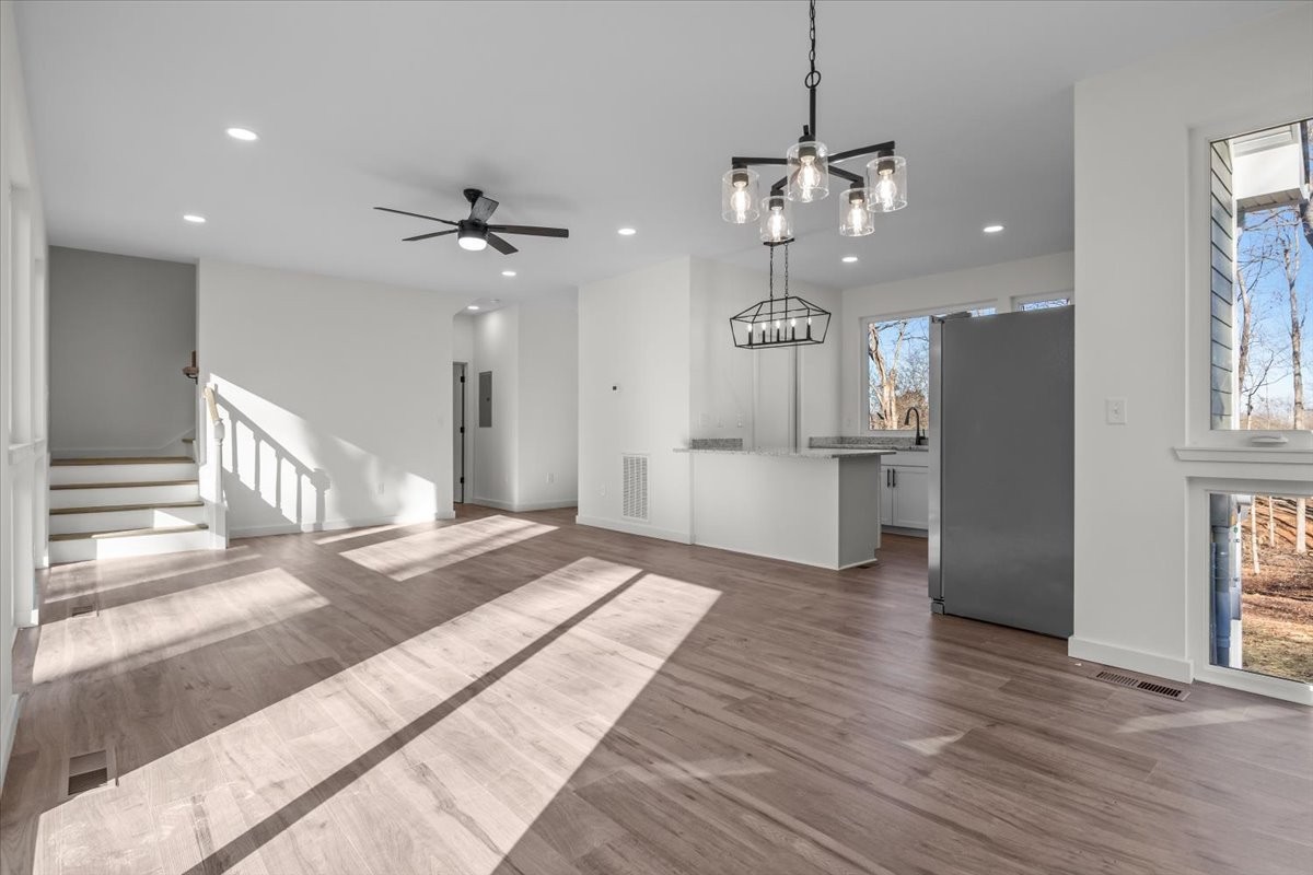 1050 Promise Land Road Charlotte, TN 37036 - Photo 7 of 29 a view of a kitchen with wooden floor and a ceiling fan
