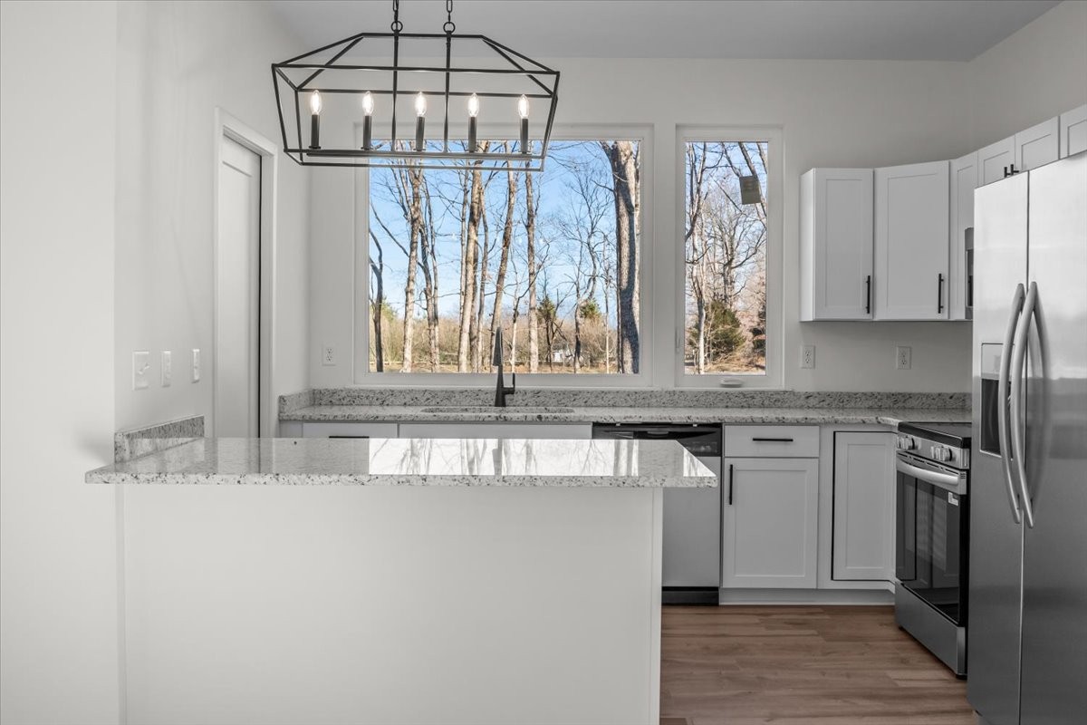 1050 Promise Land Road Charlotte, TN 37036 - Photo 8 of 29 a kitchen with stainless steel appliances granite countertop a sink and a refrigerator