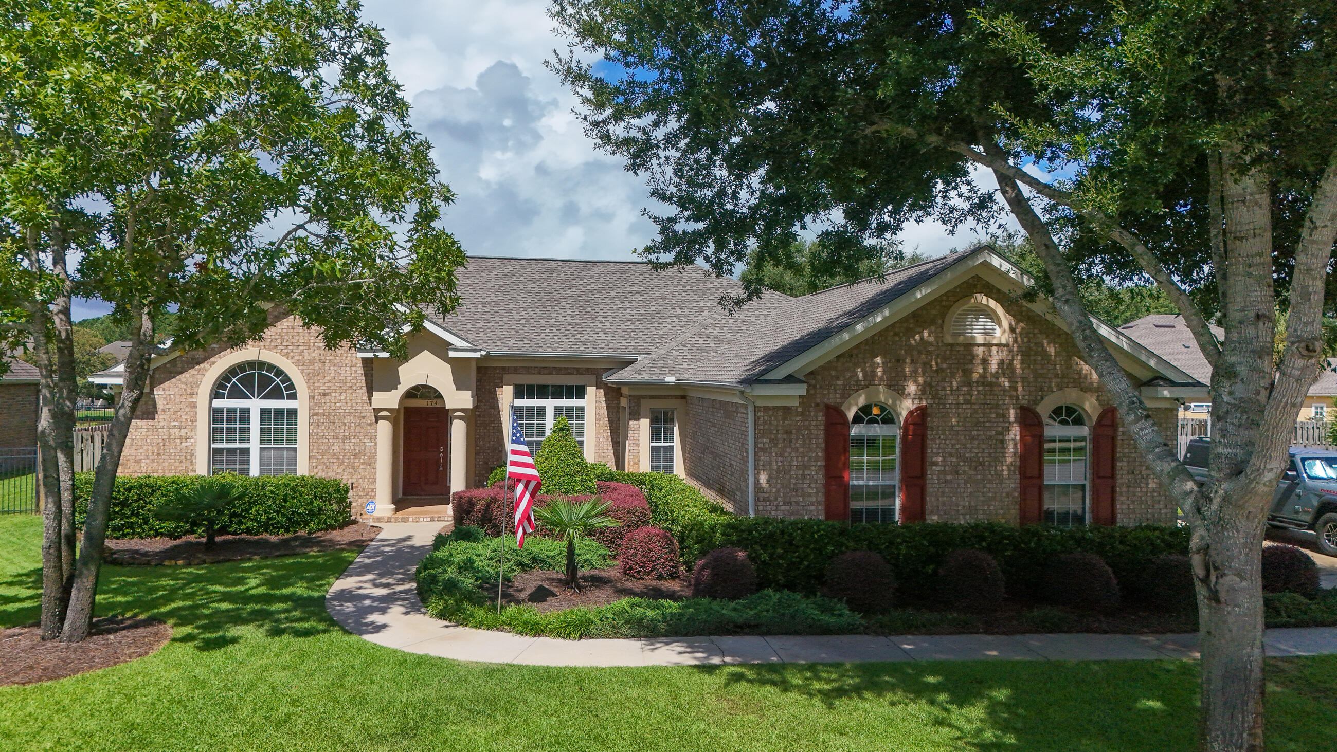 174 Mango Lane Freeport, FL 32439 - Photo 1 of 90 a front view of a house with a yard and trees