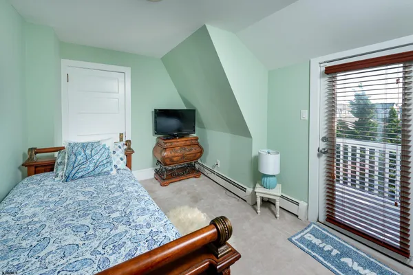 a bedroom with furniture and a window