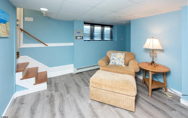 a bedroom with a bed and a lamp with wooden floor