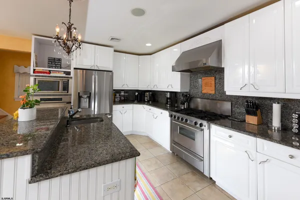 a kitchen with refrigerator and window