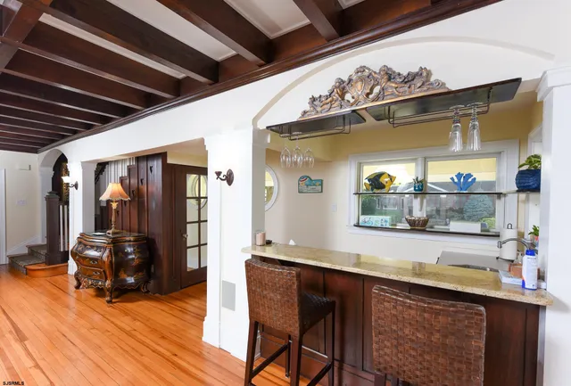 a kitchen with a sink cabinets and wooden floor