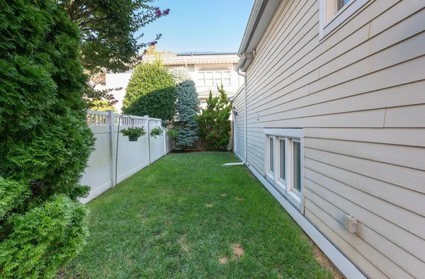 a view of a backyard with plants and a garden