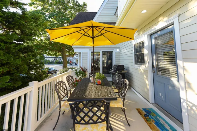 a view of balcony with furniture and umbrella