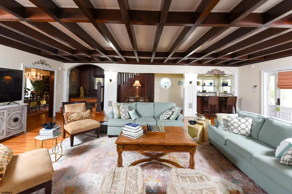 a living room with furniture and a chandelier