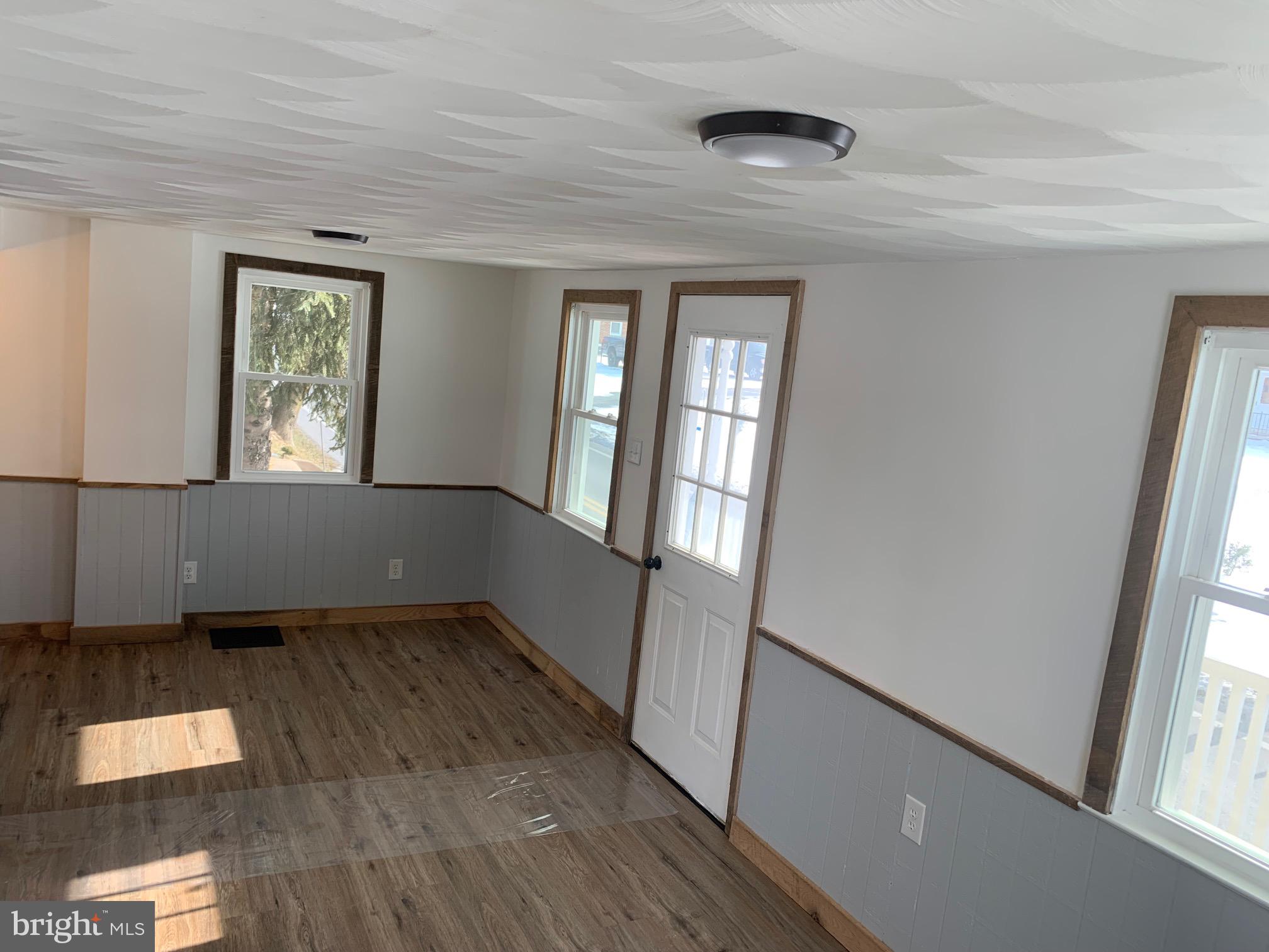 560 Blooming Grove Road Hanover, PA 17331 - Photo 12 of 37 an empty room with wooden floor and windows