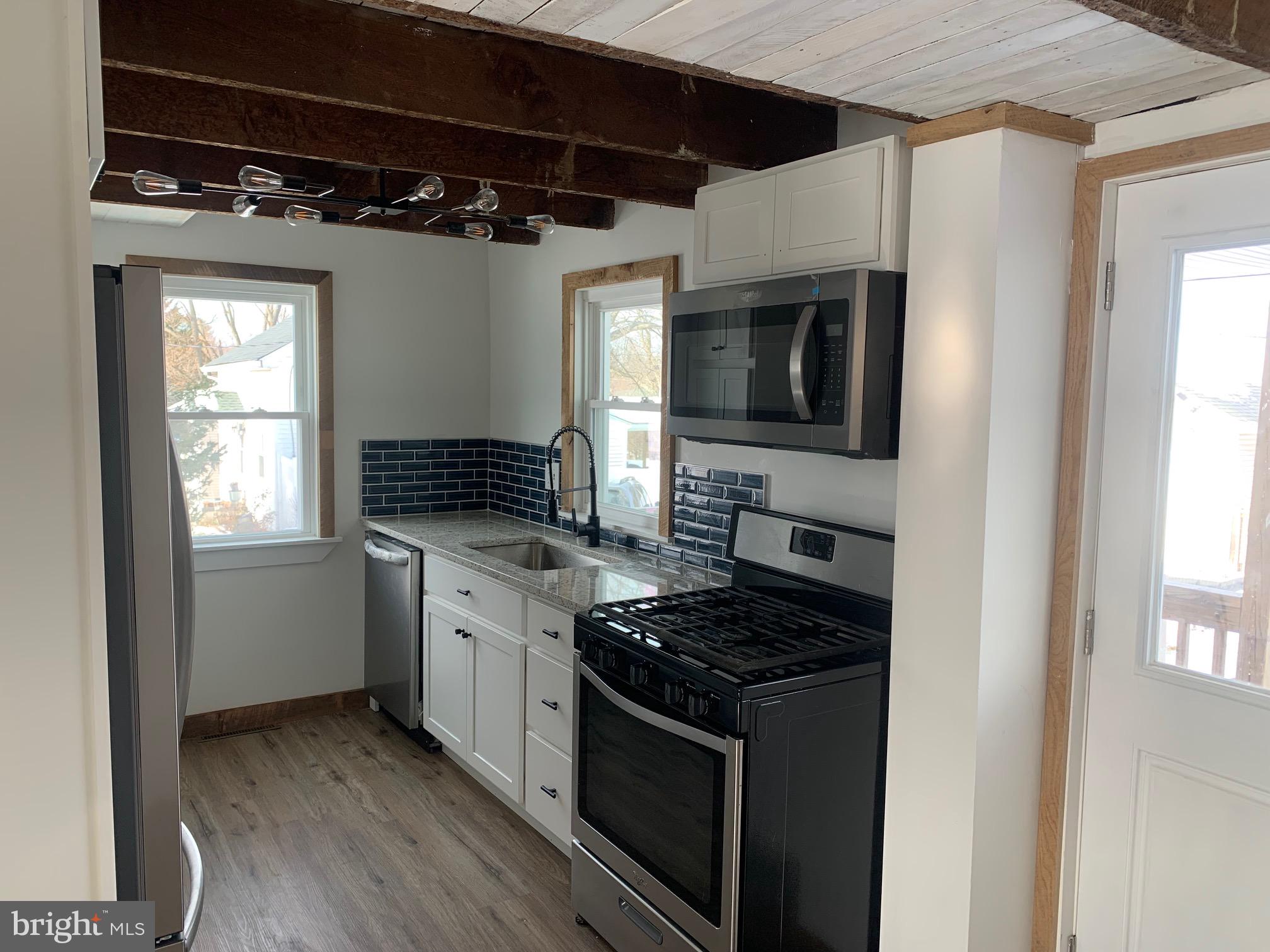 560 Blooming Grove Road Hanover, PA 17331 - Photo 8 of 37 a kitchen with a stove and a microwave