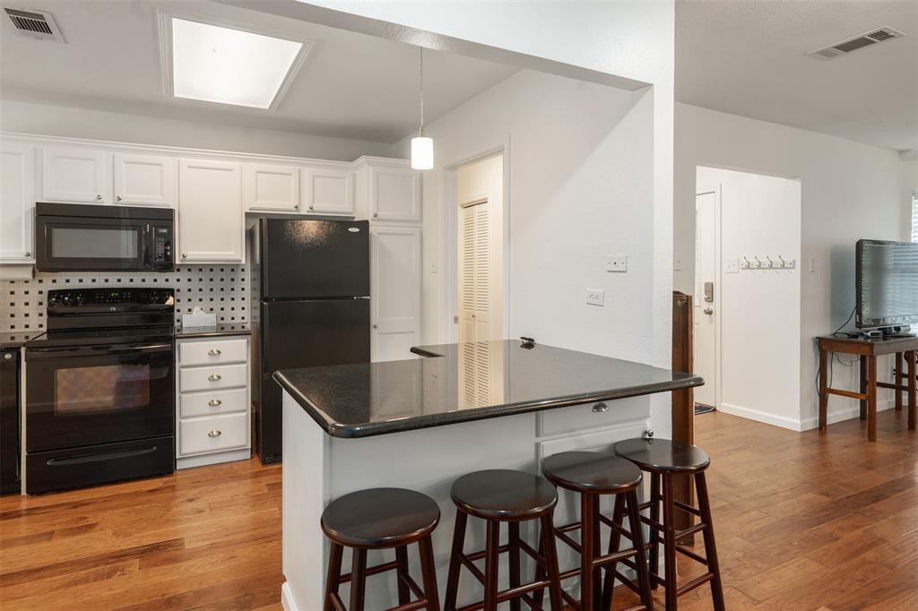 12752 Honeysuckle Circle Eustace, TX 75124 - Photo 11 of 28 Kitchen with black appliances also features a eating bar for extra seating.