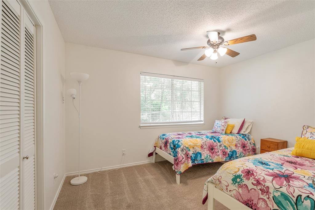 12752 Honeysuckle Circle Eustace, TX 75124 - Photo 19 of 28 Bedroom featuring carpet floors, a closet, a textured ceiling, and a ceiling fan