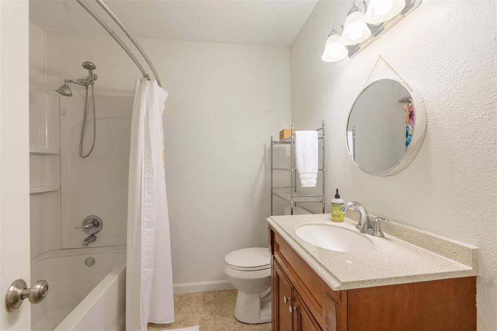 12752 Honeysuckle Circle Eustace, TX 75124 - Photo 20 of 28 Full bathroom with vanity, shower / tub combo with curtain, and tile patterned flooring