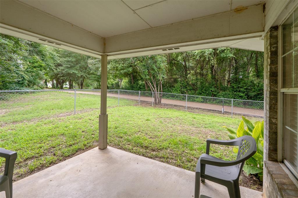12752 Honeysuckle Circle Eustace, TX 75124 - Photo 25 of 28 Fenced backyard featuring a patio area; extra space on the north side of the fenced-in backyard
