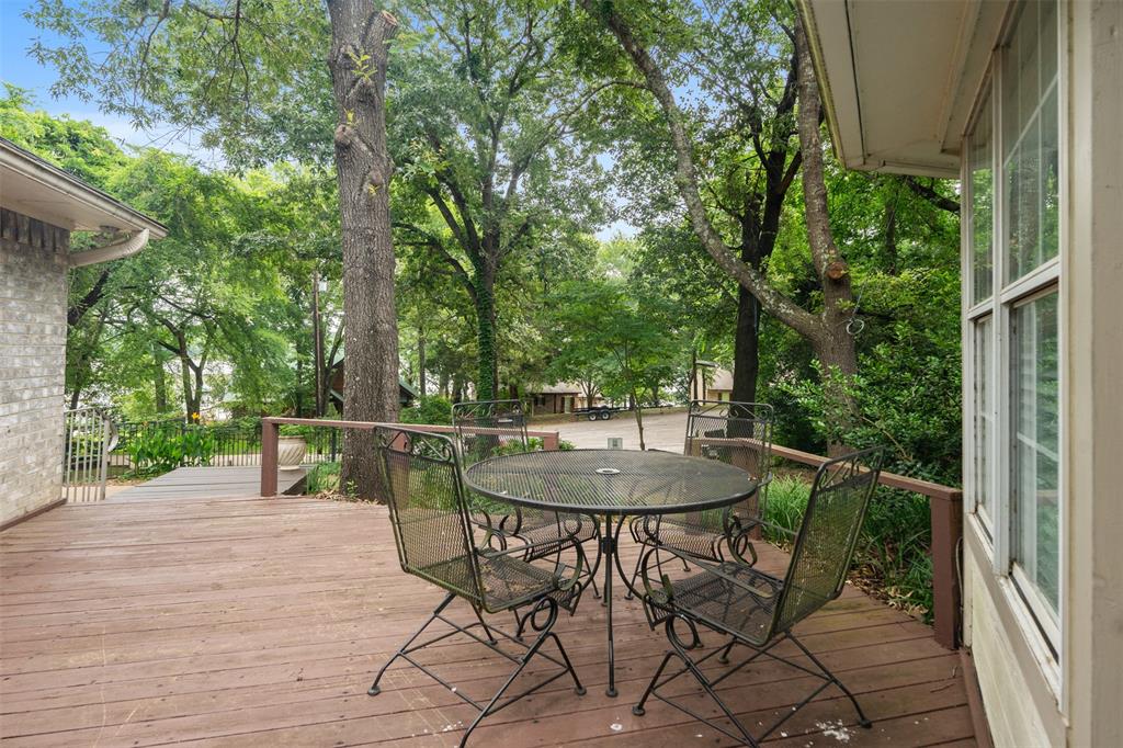 12752 Honeysuckle Circle Eustace, TX 75124 - Photo 5 of 28 Wooden deck featuring outdoor dining space and view of wooded area