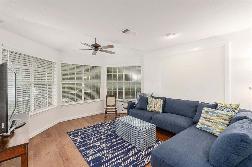 12752 Honeysuckle Circle Eustace, TX 75124 - Photo 6 of 28 Living area featuring ceiling fan, wood finished floors, and healthy amount of natural light
