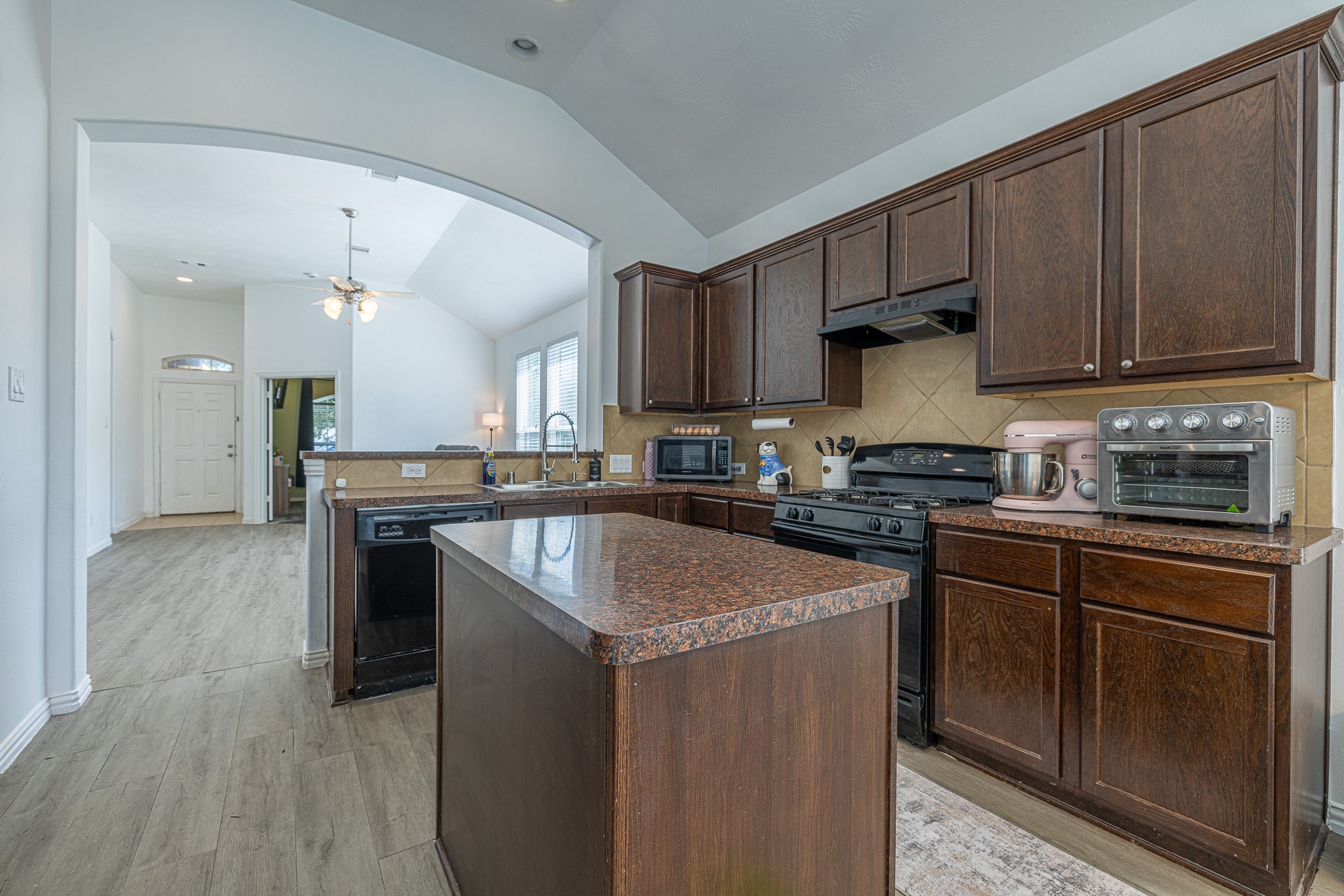 3818 Hunters Trail Baytown, TX 77521 - Photo 11 of 32 a kitchen with stainless steel appliances granite countertop a stove a sink and a refrigerator