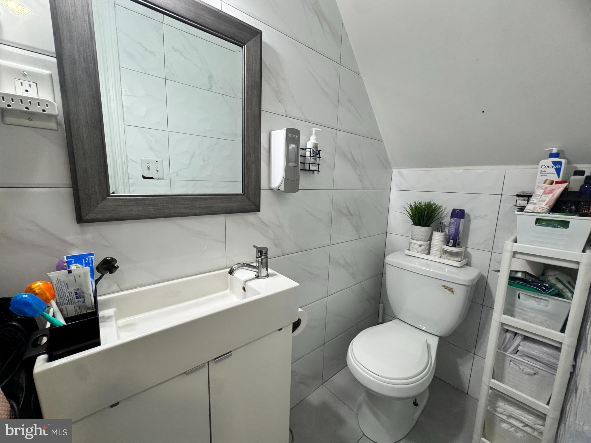 3322 Wellington Street Philadelphia, PA 19149 - Photo 13 of 18 a bathroom with a sink toilet and vanity