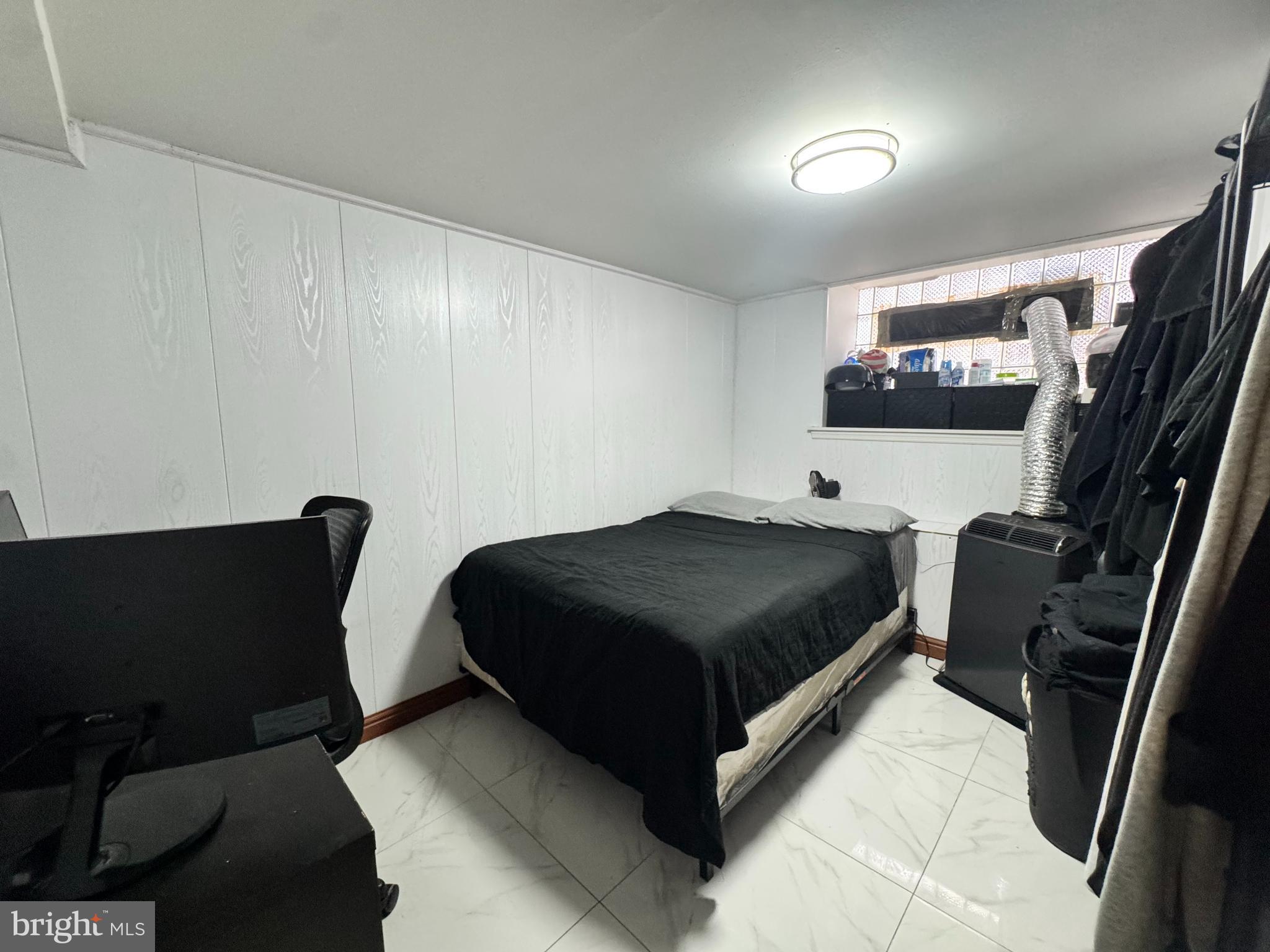 3322 Wellington Street Philadelphia, PA 19149 - Photo 14 of 18 a bedroom with a bed and a flat screen tv