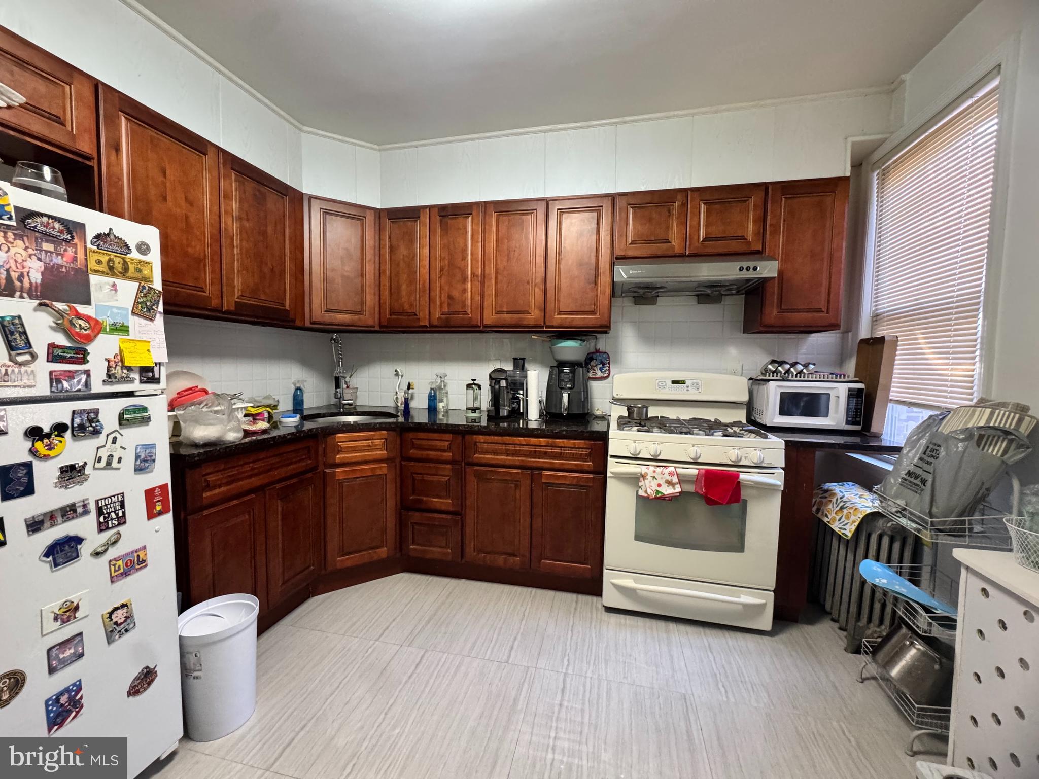 3322 Wellington Street Philadelphia, PA 19149 - Photo 15 of 18 a kitchen with stainless steel appliances a stove a sink and a refrigerator