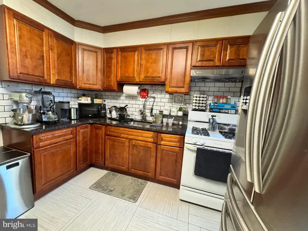 a kitchen with stainless steel appliances granite countertop a refrigerator sink and cabinets