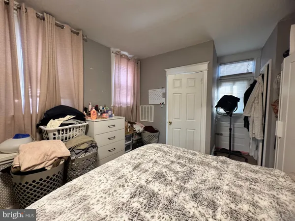 a bedroom with a bed and a closet