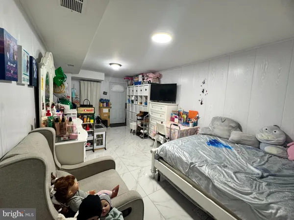 a bedroom with furniture and a flat screen tv