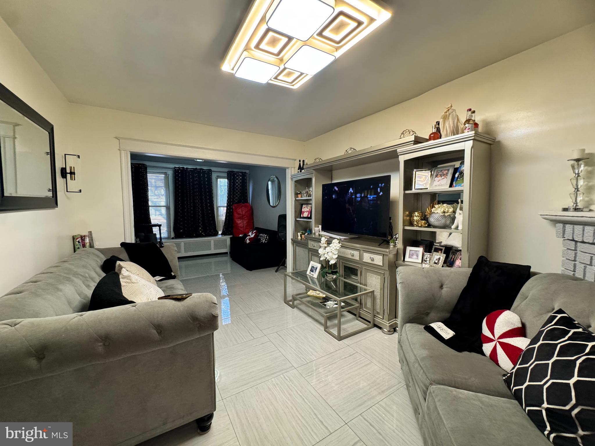 3322 Wellington Street Philadelphia, PA 19149 - Photo 6 of 18 a living room with furniture and a flat screen tv