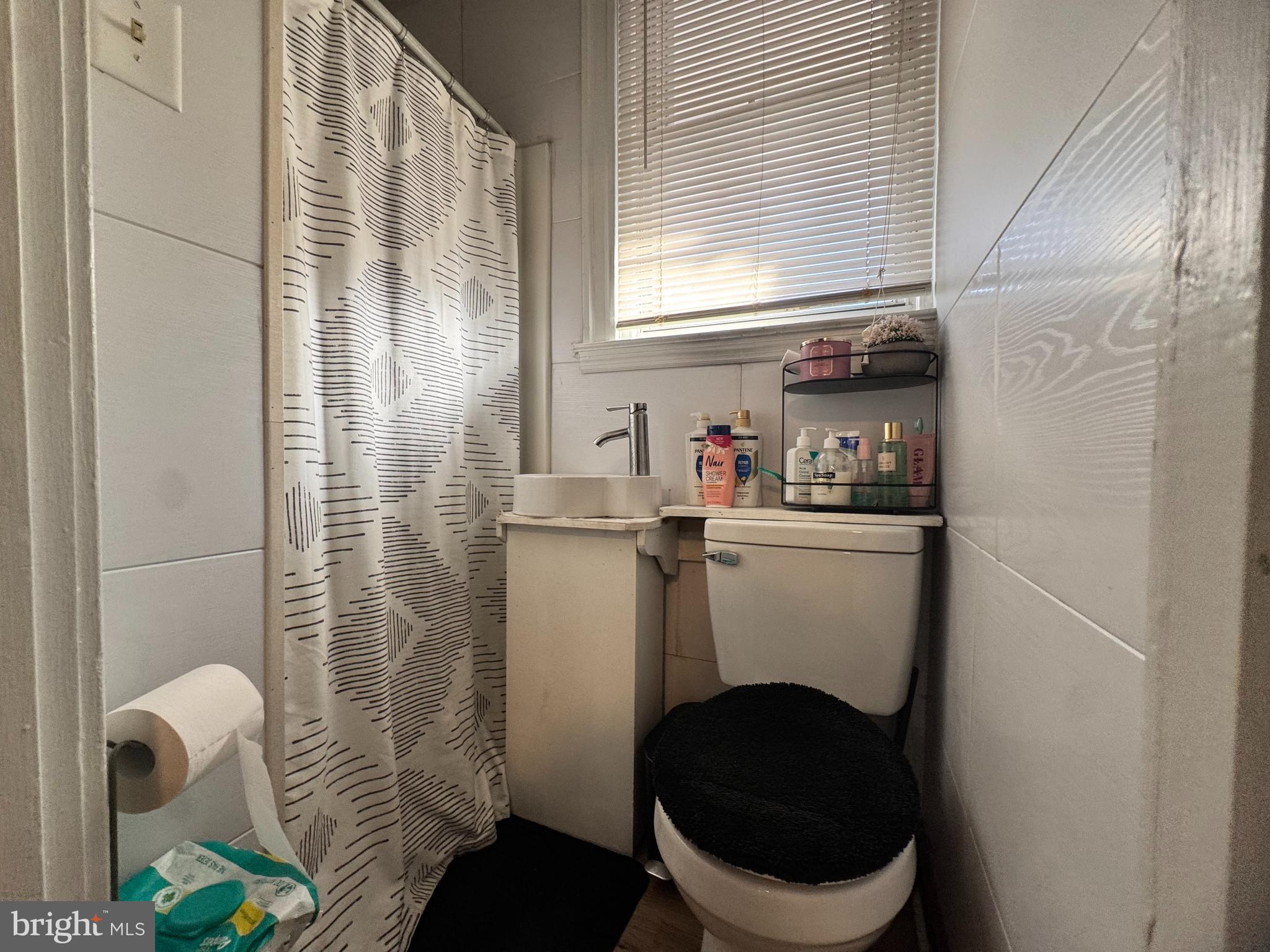 3322 Wellington Street Philadelphia, PA 19149 - Photo 8 of 18 a bathroom with a sink a toilet and a shower