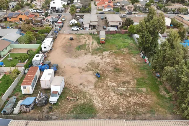 an aerial view of residential houses with outdoor space