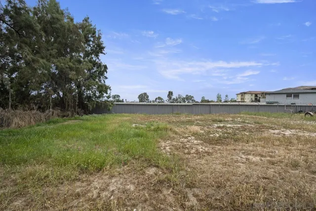 a view of a lake with houses in the back