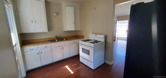 a kitchen with sink cabinets and window