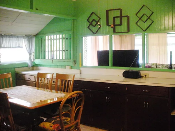a kitchen with stainless steel appliances a table chairs and a window