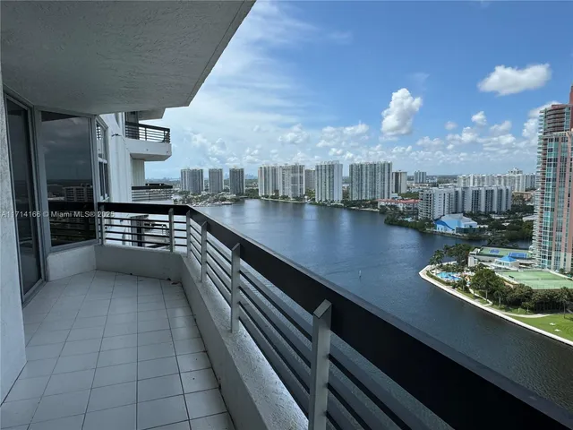 a view of a chairs and table in a balcony